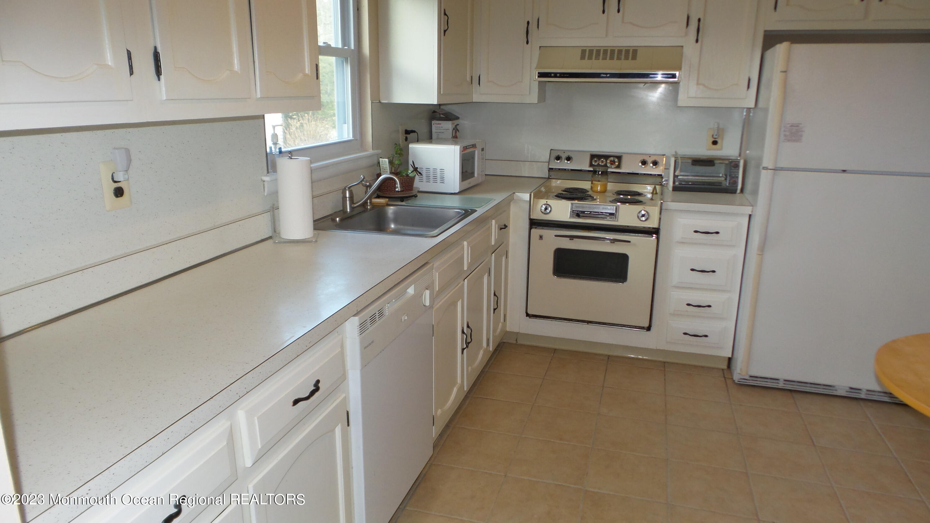 17 Blake Circle Brick, NJ 08724 - Photo 5 of 18 a kitchen with white cabinets and white appliances