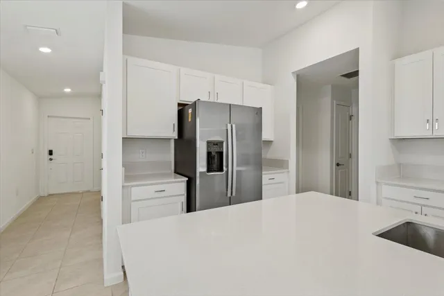 a kitchen with stainless steel appliances a refrigerator and cabinets