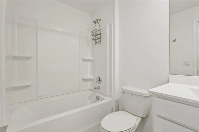 a bathroom with a toilet and a bathtub