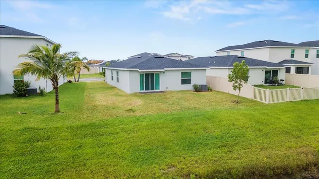 a view of a house with a backyard