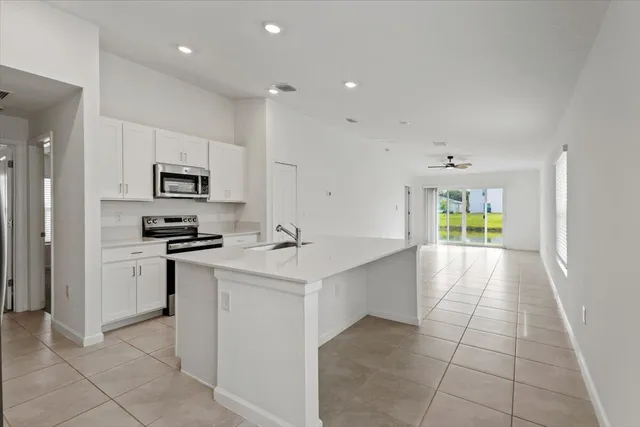 a kitchen with granite countertop a stove top oven and cabinets