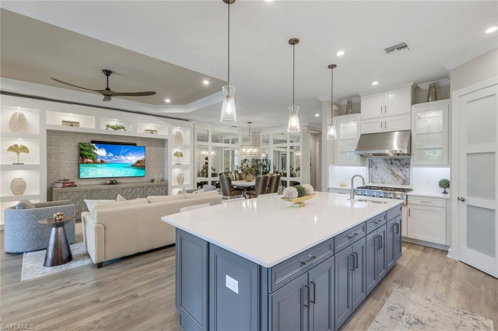 8935 Cappello Court Naples, FL 34119 - Photo 11 of 50 a kitchen with kitchen island a sink a counter top space stainless steel appliances and a window