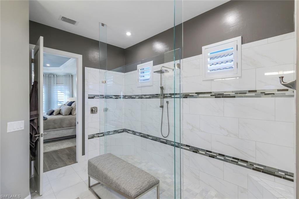 8935 Cappello Court Naples, FL 34119 - Photo 15 of 50 a bathroom with a tub and shower