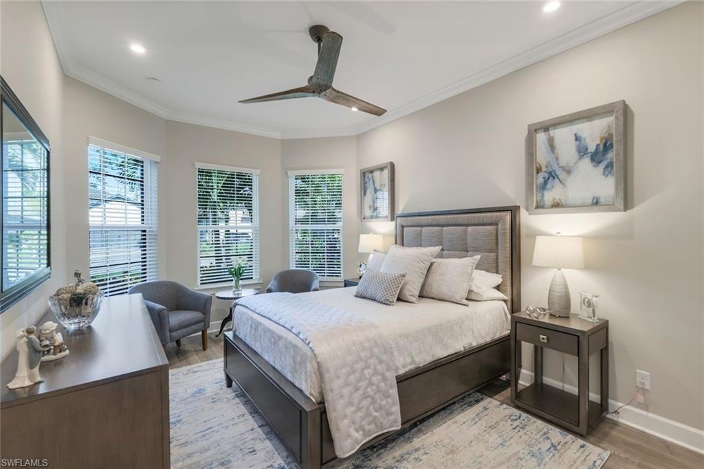 8935 Cappello Court Naples, FL 34119 - Photo 17 of 50 a bedroom with a bed and glass windows
