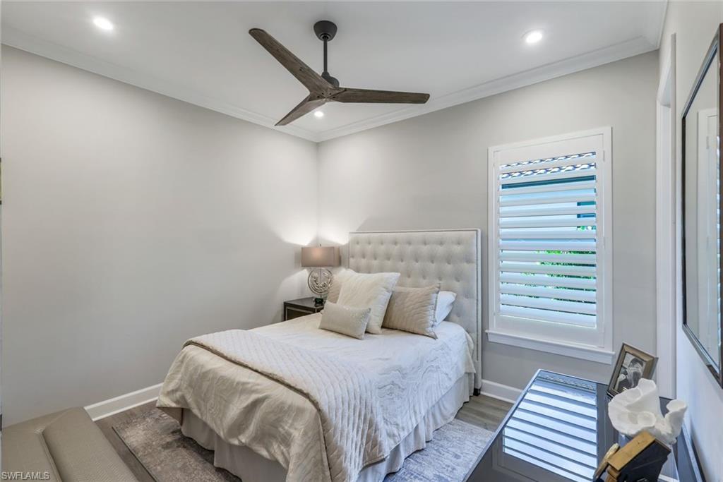 8935 Cappello Court Naples, FL 34119 - Photo 19 of 50 a bedroom with a bed and a window