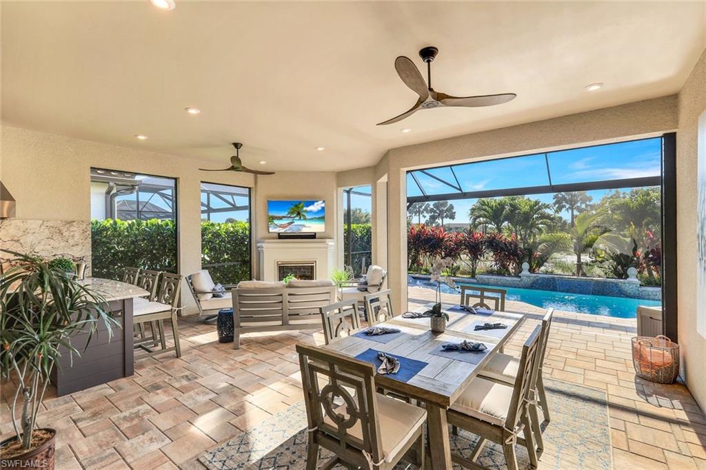 8935 Cappello Court Naples, FL 34119 - Photo 24 of 50 a living room with furniture and a large window