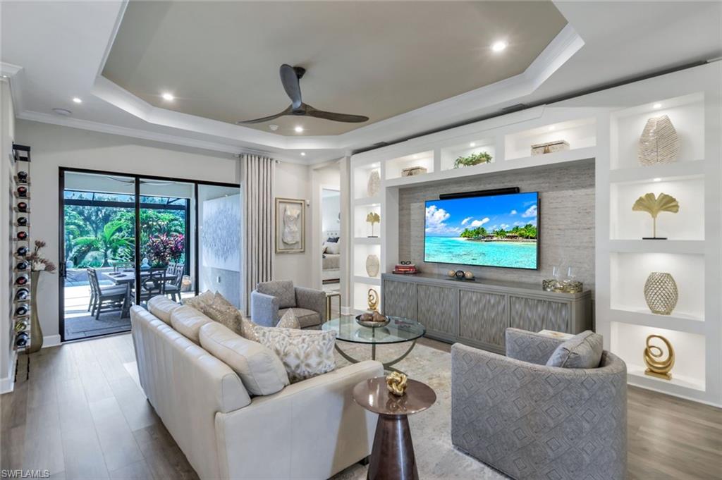 8935 Cappello Court Naples, FL 34119 - Photo 3 of 50 a living room with furniture and a flat screen tv