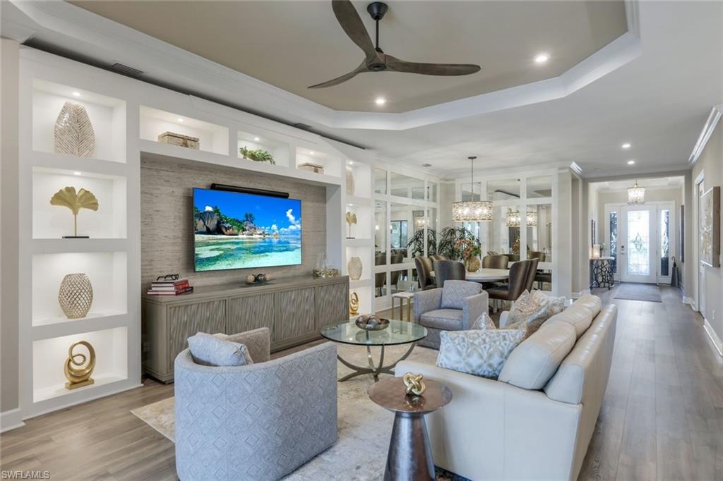 8935 Cappello Court Naples, FL 34119 - Photo 4 of 50 a living room with furniture and a flat screen tv
