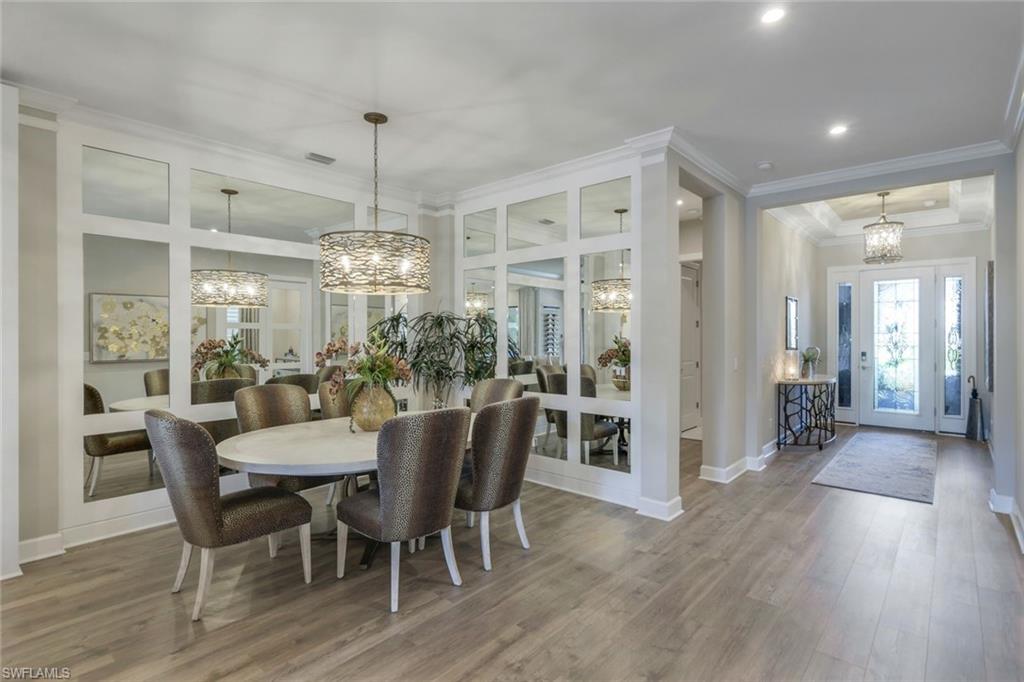 8935 Cappello Court Naples, FL 34119 - Photo 5 of 50 a view of a dining room with furniture window and wooden floor