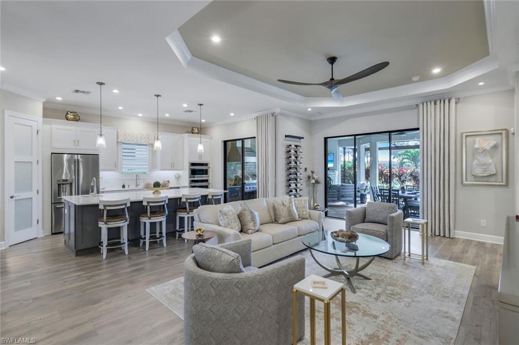 8935 Cappello Court Naples, FL 34119 - Photo 6 of 50 a living room with furniture kitchen and a large window