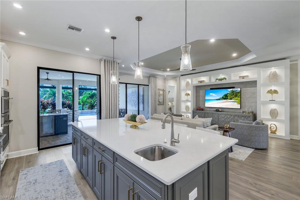 8935 Cappello Court Naples, FL 34119 - Photo 10 of 50 a kitchen with sink refrigerator and couches