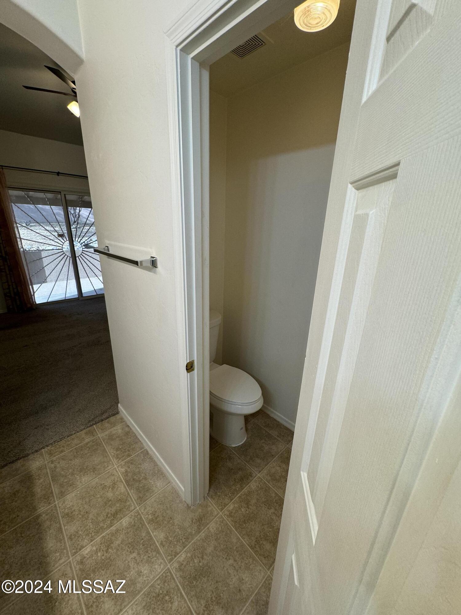 1841 America Court Rio Rico, AZ 85648 - Photo 25 of 38 a bathroom with a granite countertop shower and a toilet
