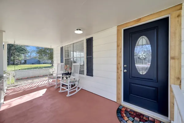 a living room with a bed furniture and a window