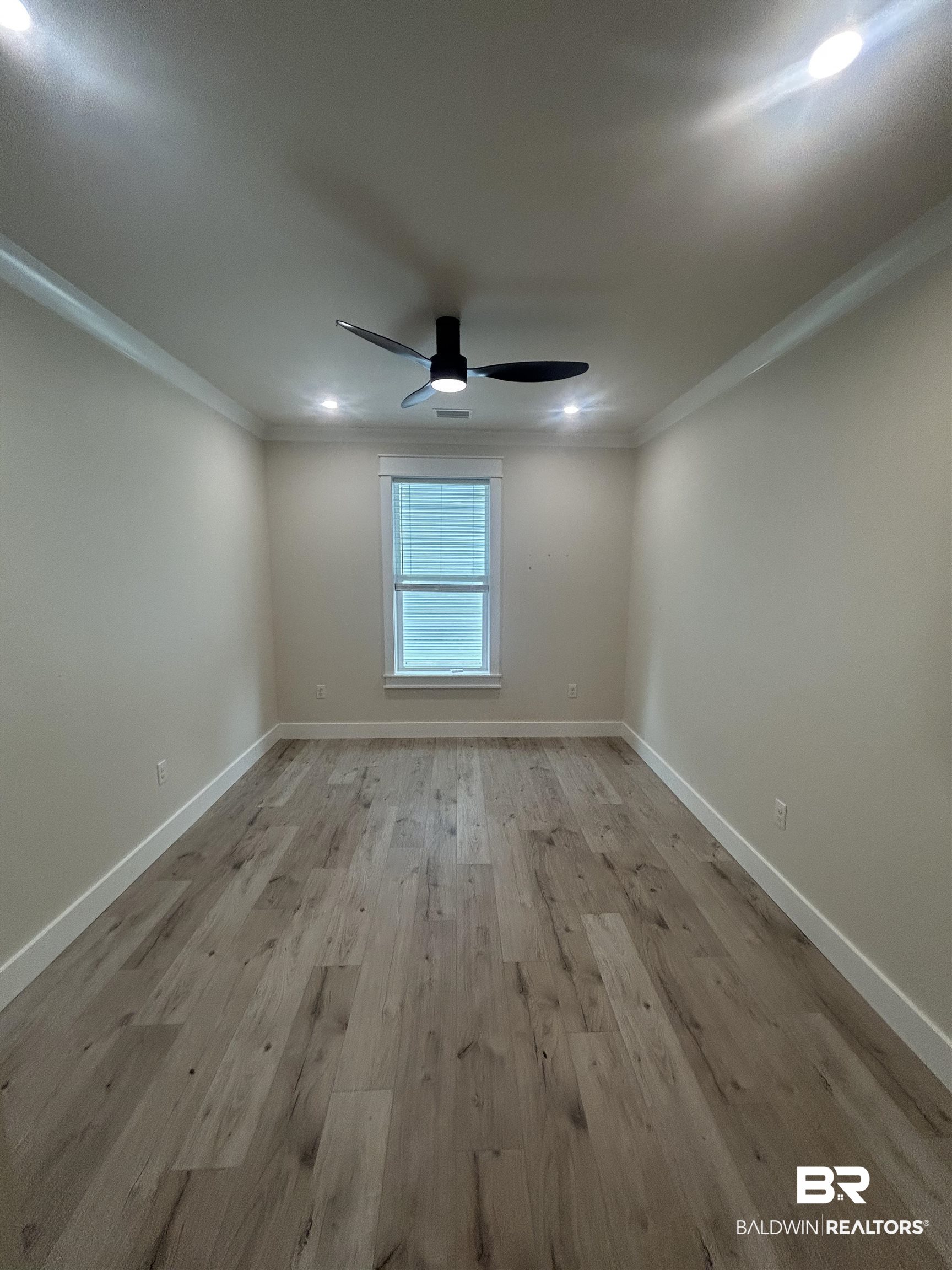 5122 Pine Road Orange Beach, AL 36561 - Photo 16 of 24 Empty room featuring light wood-type flooring, ceiling fan, recessed lighting, and crown molding