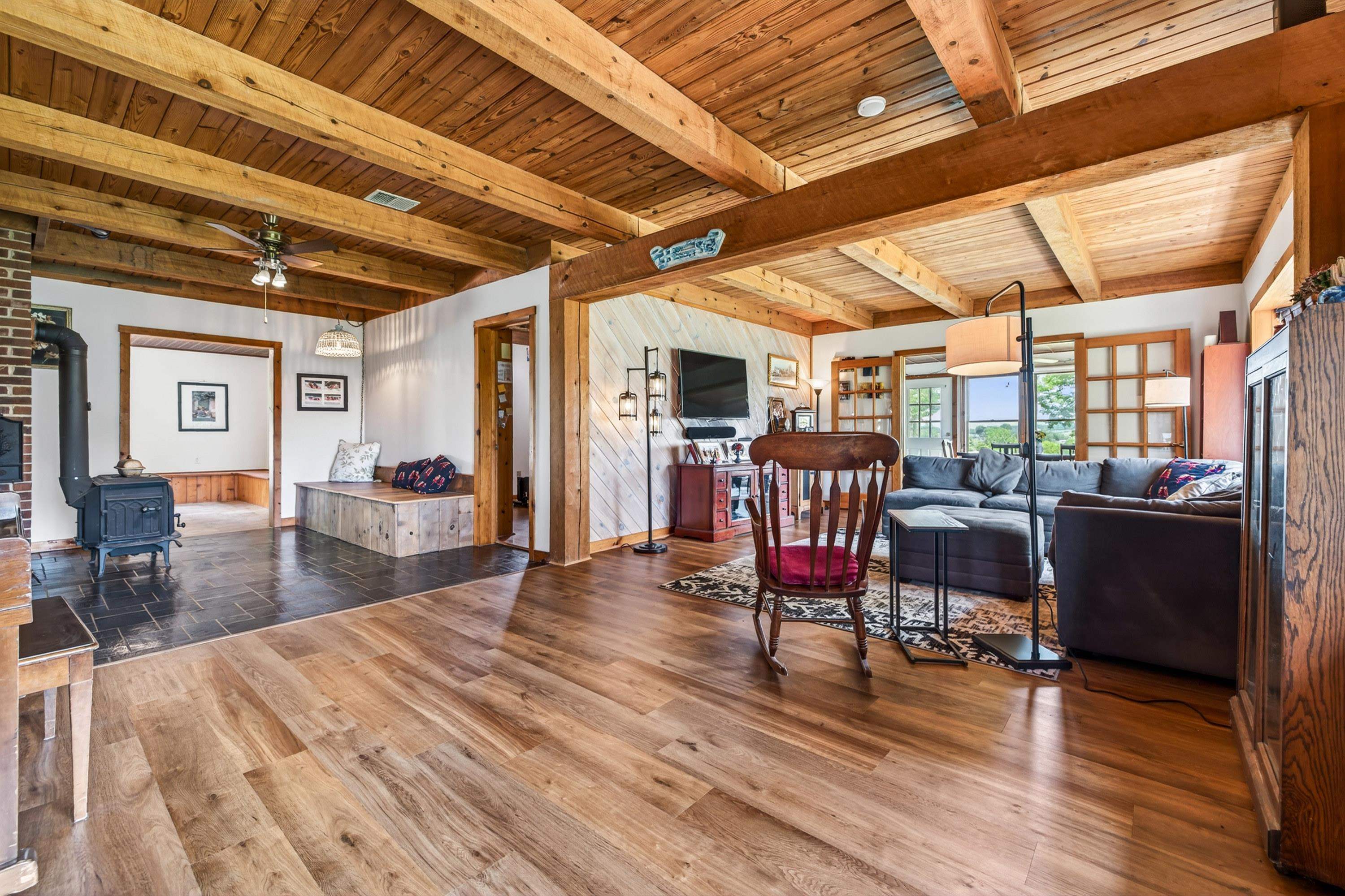 3980 Greenmount Road Harrisonburg, VA 22802 - Photo 8 of 75 The living room is expansive and features hardwood flooring, large windows, decorative ceilings, and plenty of space for gathering with family and friends.