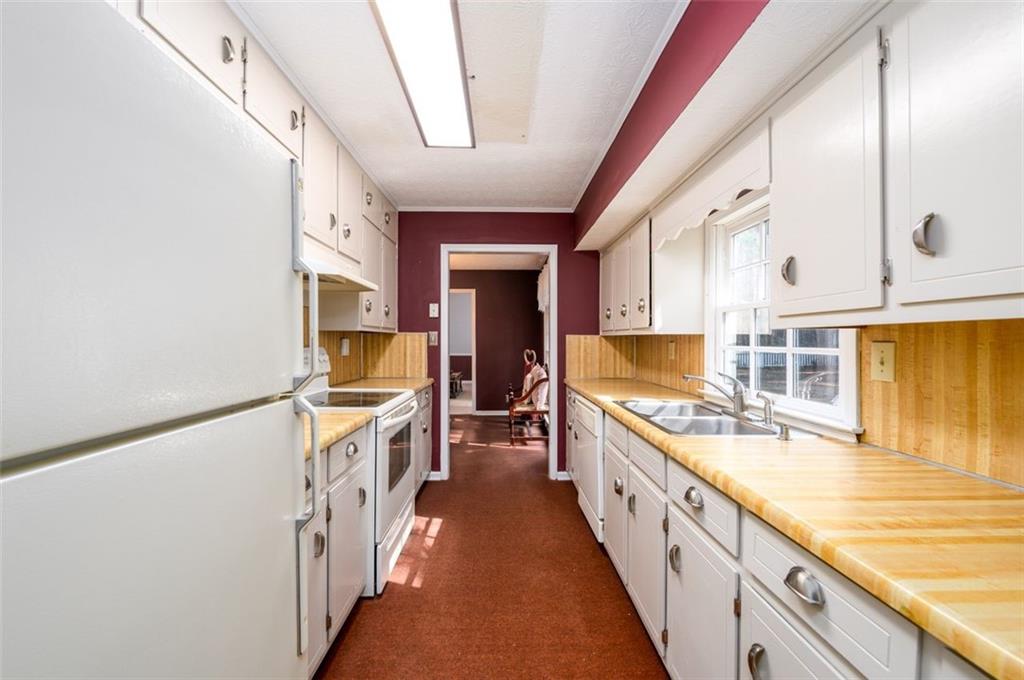 4304 Riverside Drive Southwest Lilburn, GA 30047 - Photo 11 of 33 a large white kitchen with a large window