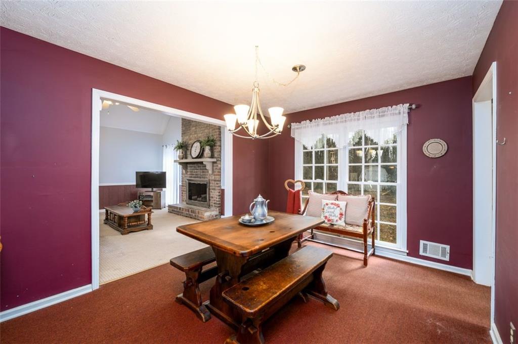 4304 Riverside Drive Southwest Lilburn, GA 30047 - Photo 12 of 33 a living room with furniture a chandelier and a window