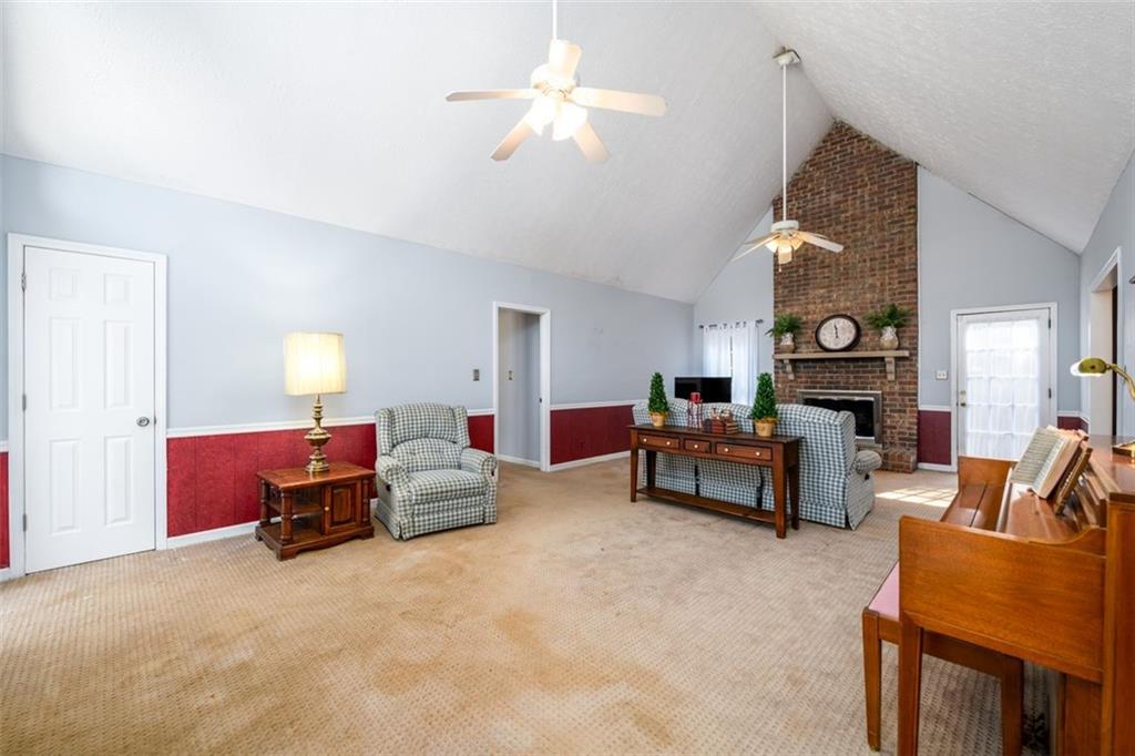 4304 Riverside Drive Southwest Lilburn, GA 30047 - Photo 15 of 33 a living room with furniture and a chandelier