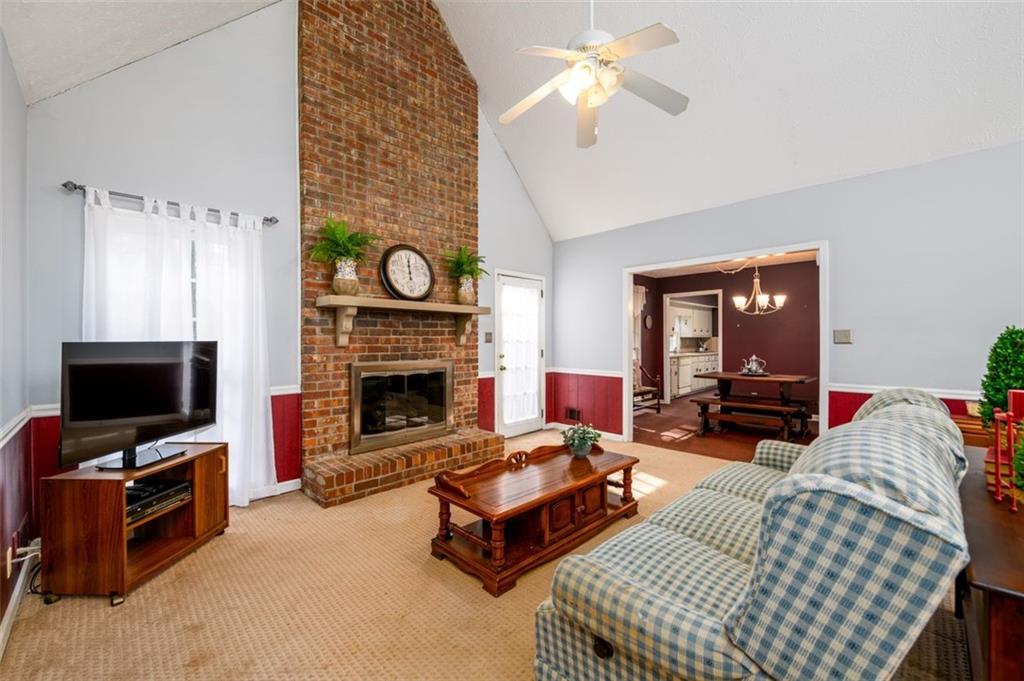 4304 Riverside Drive Southwest Lilburn, GA 30047 - Photo 17 of 33 a living room with furniture a flat screen tv and a fireplace