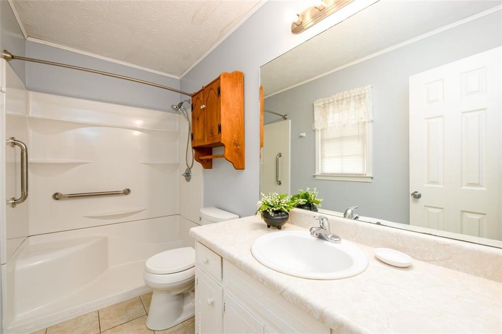 4304 Riverside Drive Southwest Lilburn, GA 30047 - Photo 21 of 33 a bathroom with a sink a toilet and shower