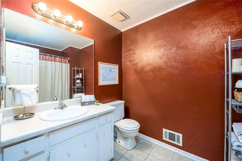 4304 Riverside Drive Southwest Lilburn, GA 30047 - Photo 26 of 33 a bathroom with a granite countertop sink toilet and shower