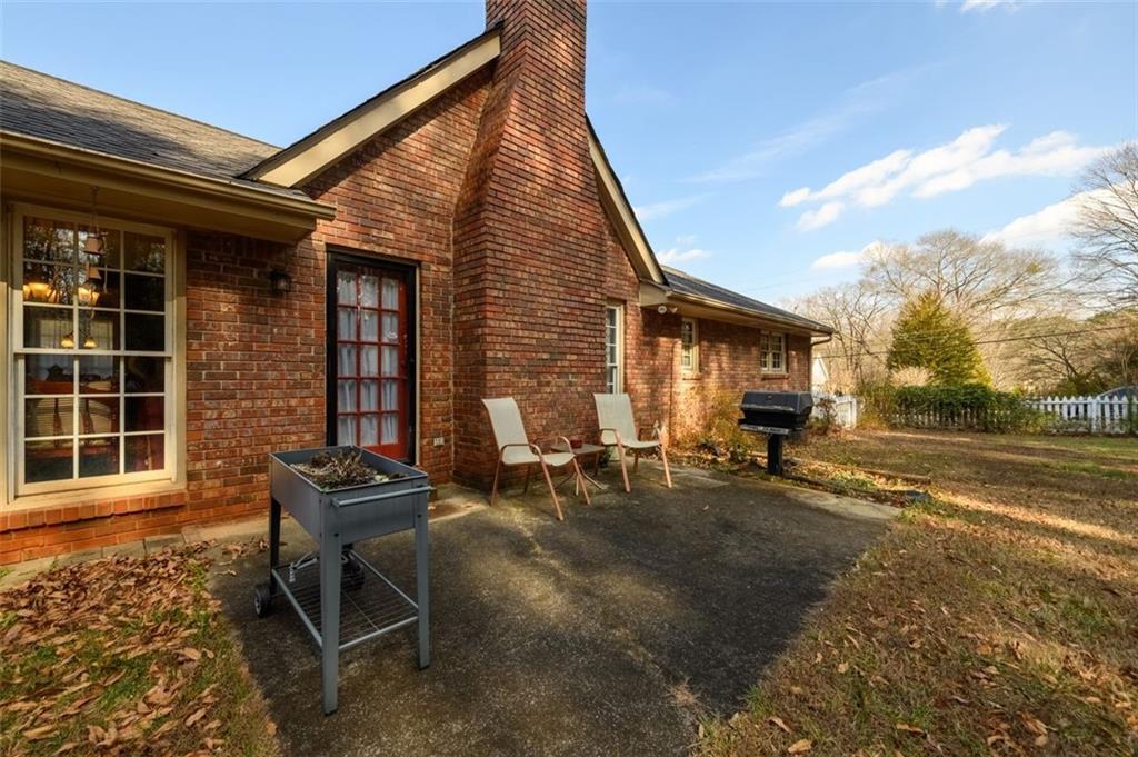 4304 Riverside Drive Southwest Lilburn, GA 30047 - Photo 27 of 33 a view of a house with backyard and sitting area