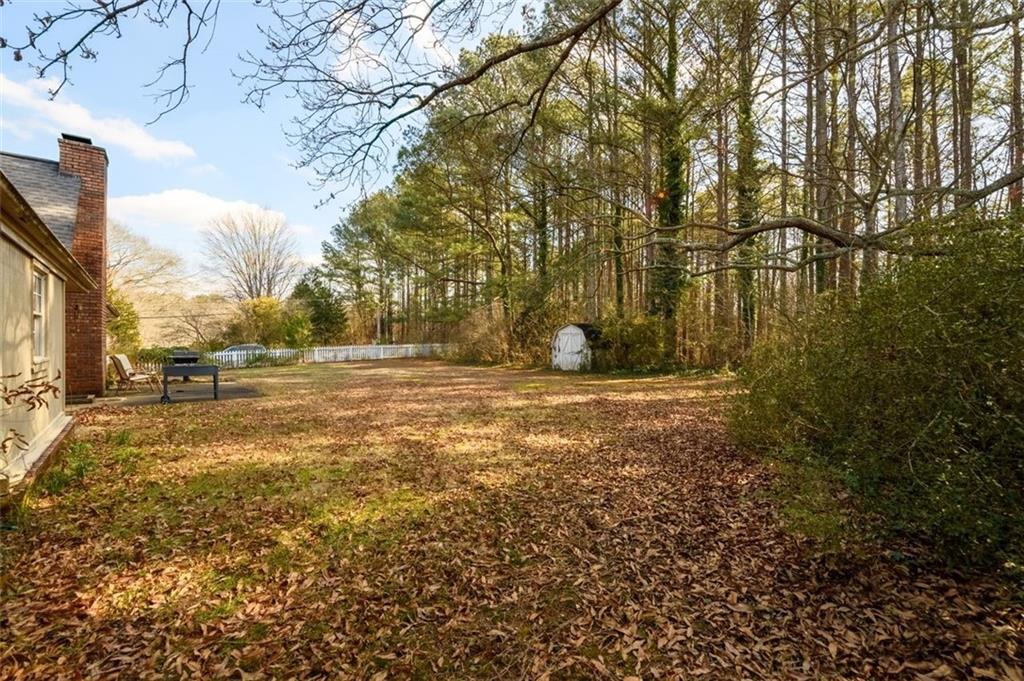 4304 Riverside Drive Southwest Lilburn, GA 30047 - Photo 29 of 33 a view of dirt yard with a large tree