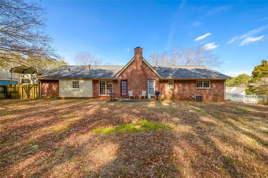 4304 Riverside Drive Southwest Lilburn, GA 30047 - Photo 30 of 33 a view of a yard in front of a house with large tree