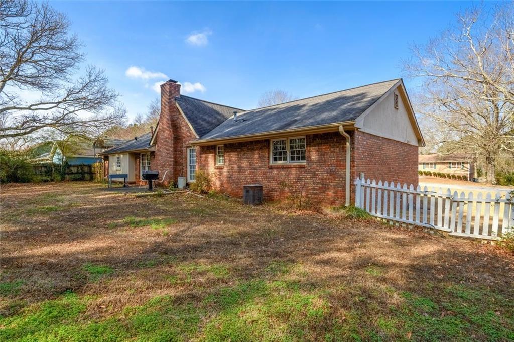 4304 Riverside Drive Southwest Lilburn, GA 30047 - Photo 31 of 33 a front view of a house with a yard