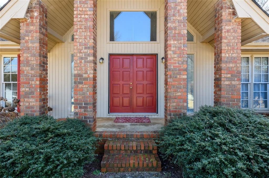 4304 Riverside Drive Southwest Lilburn, GA 30047 - Photo 4 of 33 a view of a brick building next to a yard
