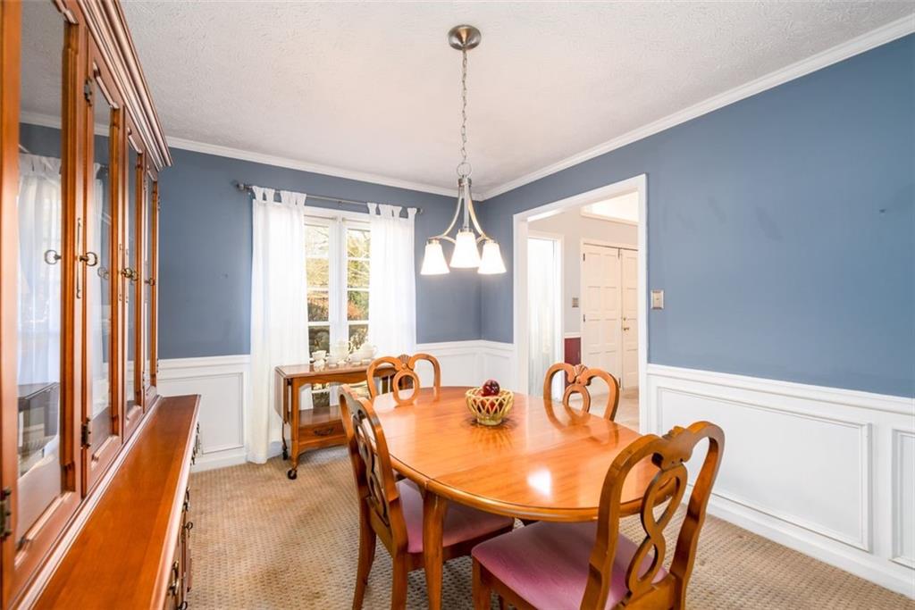 4304 Riverside Drive Southwest Lilburn, GA 30047 - Photo 7 of 33 a view of a dining room with furniture window and wooden floor