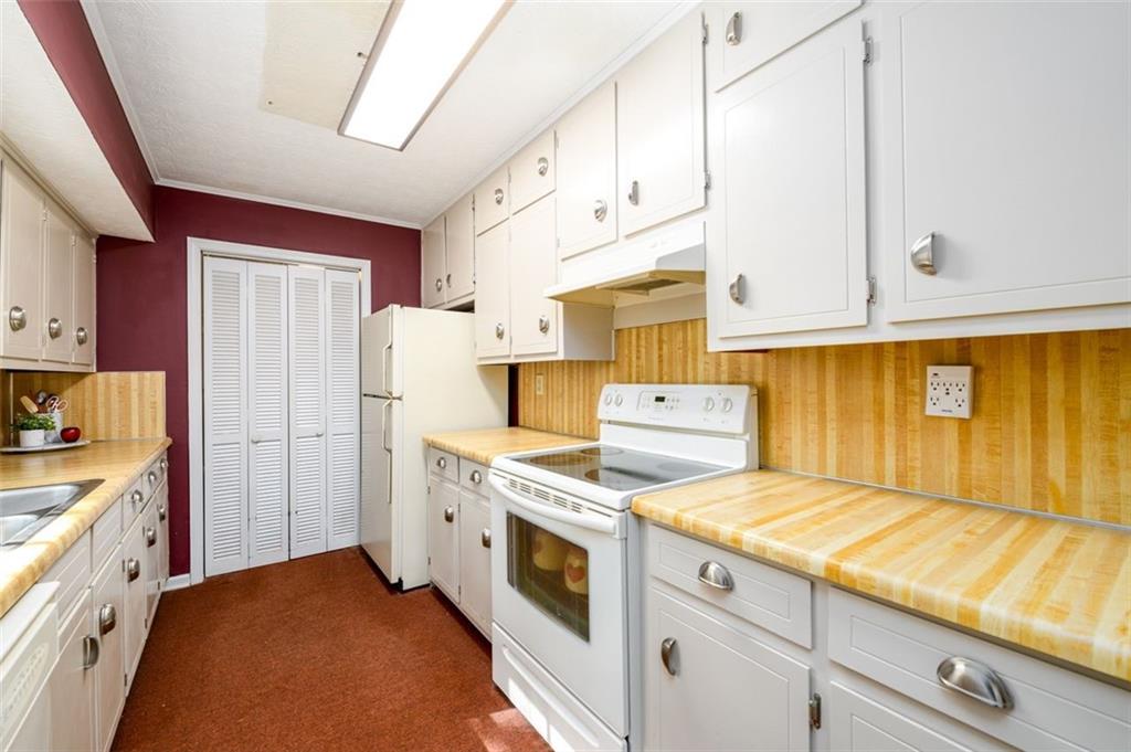 4304 Riverside Drive Southwest Lilburn, GA 30047 - Photo 9 of 33 a kitchen with cabinets appliances and wooden floor