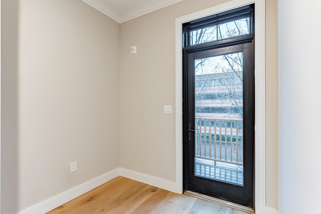 157 Everett Street, Unit 302 Boston, MA 02134 - Photo 8 of 11 a view of an empty room with wooden floor and a window