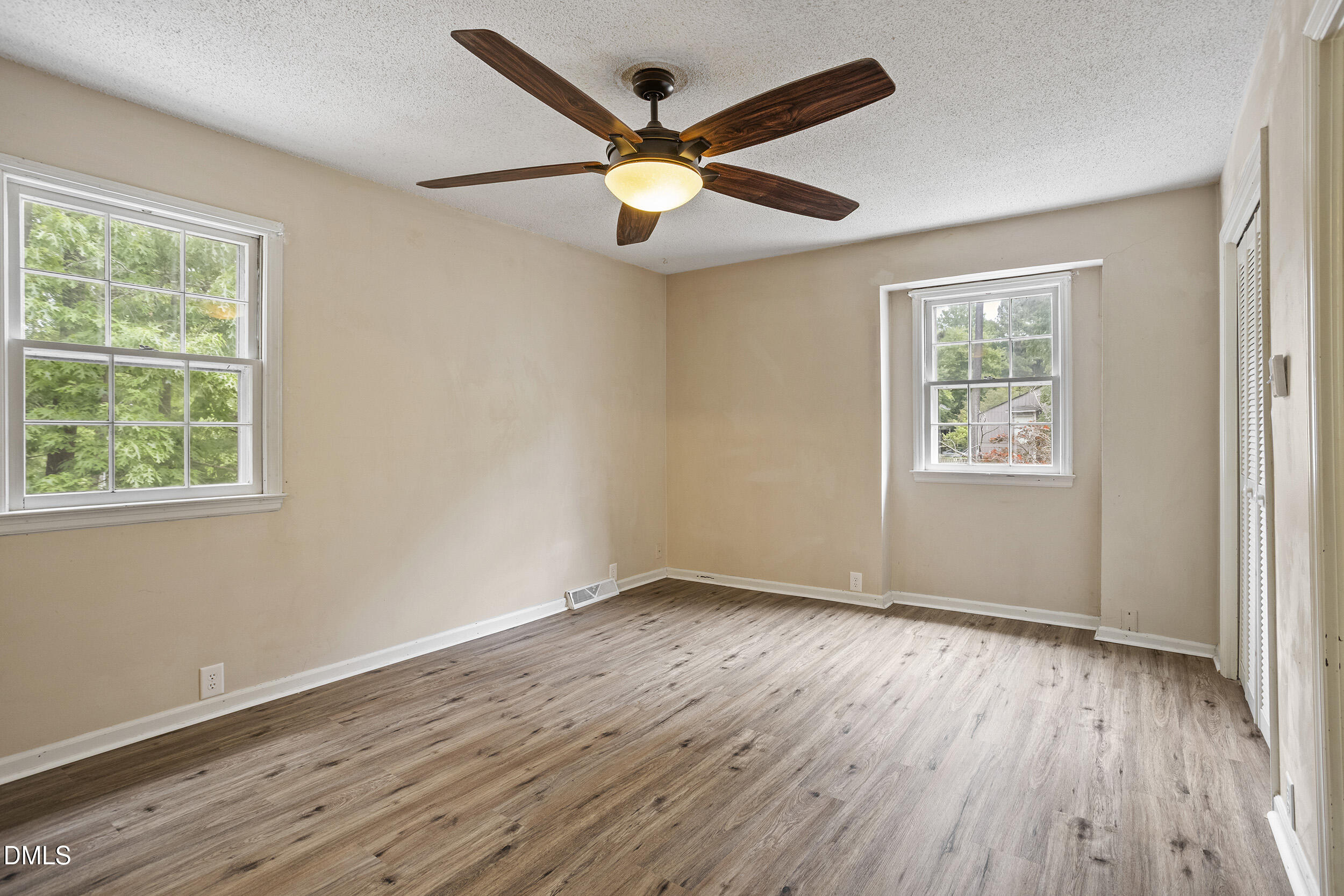1801 Quail Ridge Road Raleigh, NC 27609 - Photo 15 of 29 a view of an empty room with wooden floor and a window