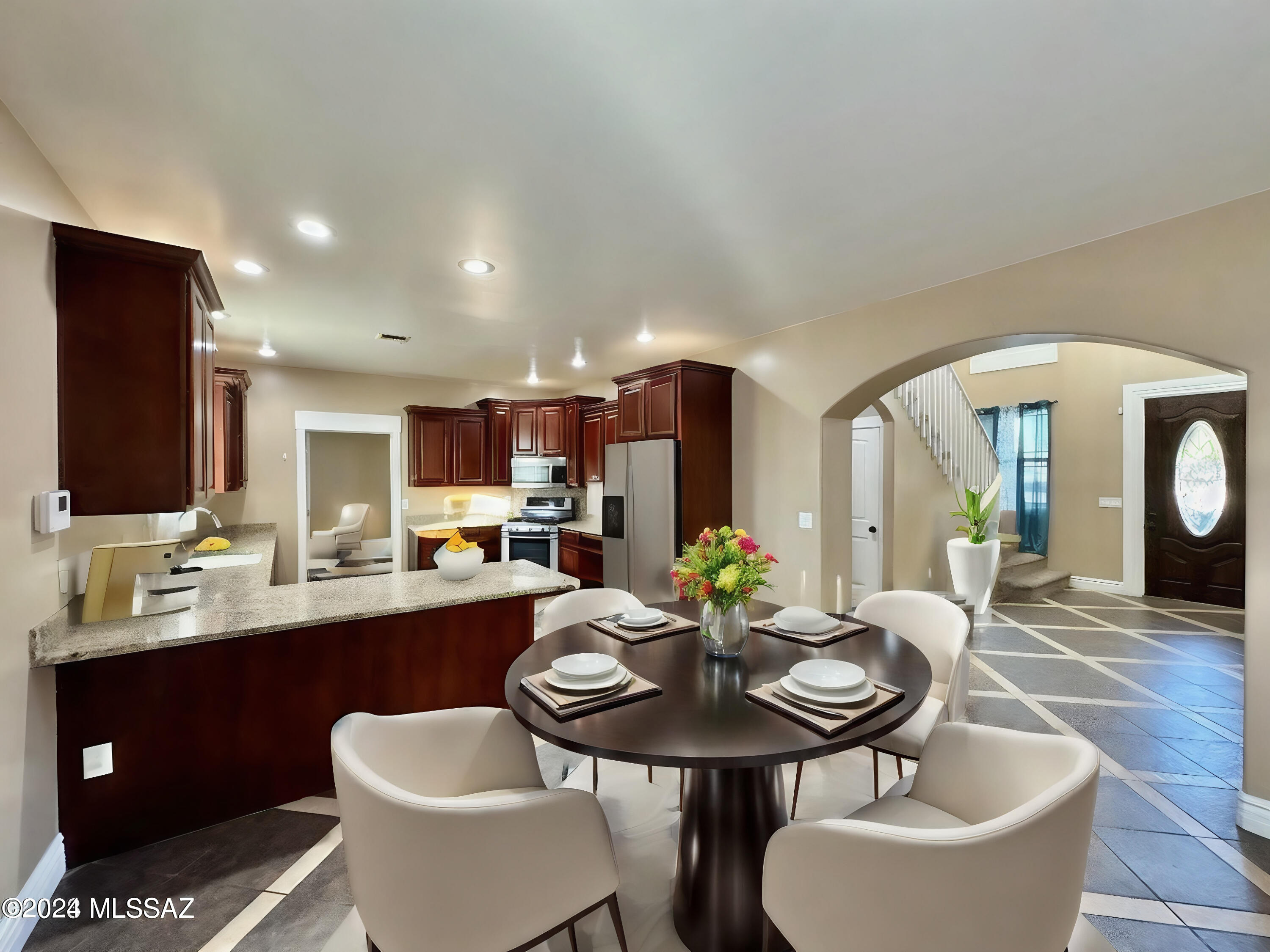 508 Eagle Meadow Loop Thatcher, AZ 85552 - Photo 6 of 32 a kitchen with a dining table chairs and a stove