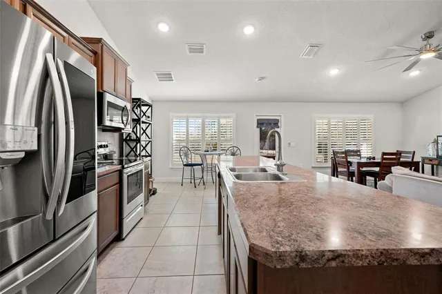 a kitchen with stainless steel appliances granite countertop a sink counter space and a stove