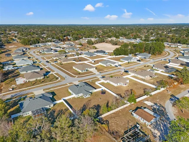 an aerial view of a residential apartment building with a yard