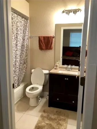 a bathroom with a toilet a sink and a mirror