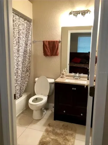 a bathroom with a toilet a sink and a mirror