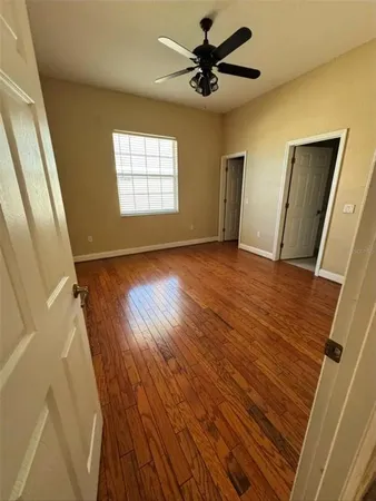 wooden floor in an empty room with a window