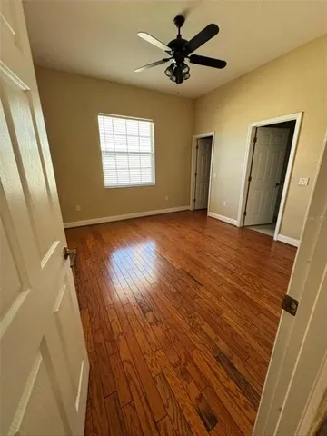 wooden floor in an empty room with a window