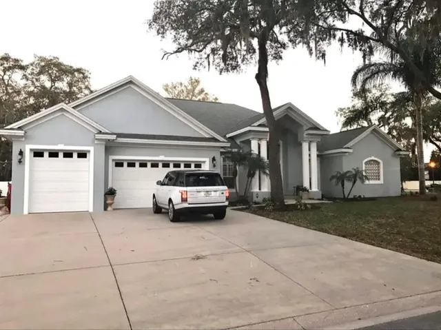 a car parked in front of white house