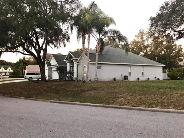 a front view of house with yard and trees