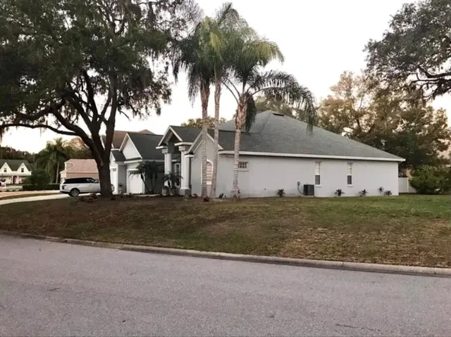 a front view of house with yard and trees