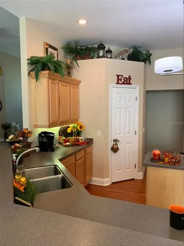 a kitchen with a refrigerator and a sink
