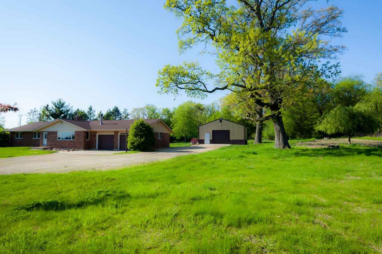 18660 Burr Oak Road Capron, IL 61012 - Photo 1 of 25 a front view of a house with a yard and trees