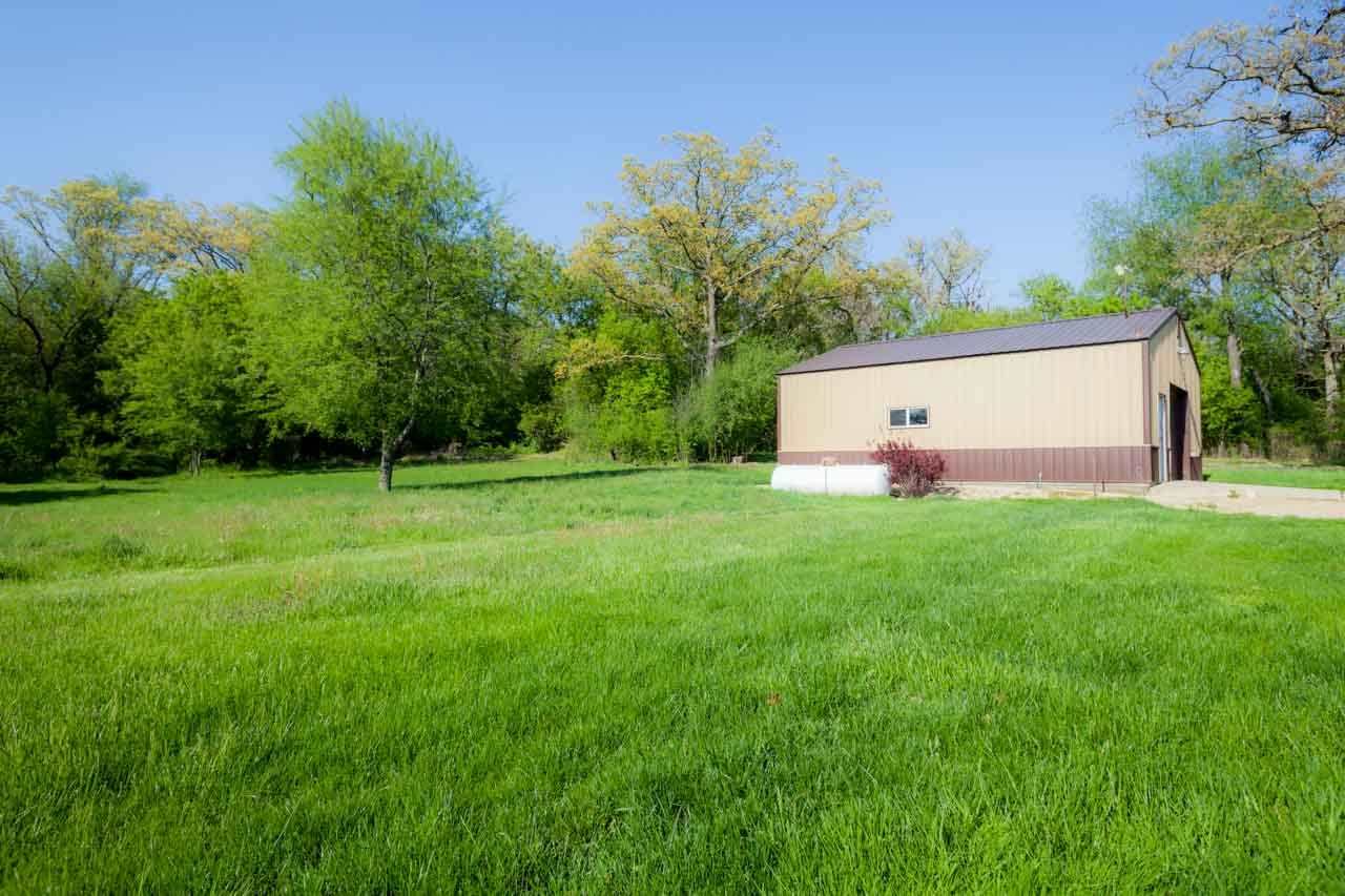 18660 Burr Oak Road Capron, IL 61012 - Photo 21 of 25 a view of a backyard with plants and large trees