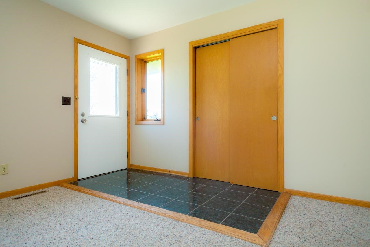 18660 Burr Oak Road Capron, IL 61012 - Photo 4 of 25 an empty room with wooden floor and windows