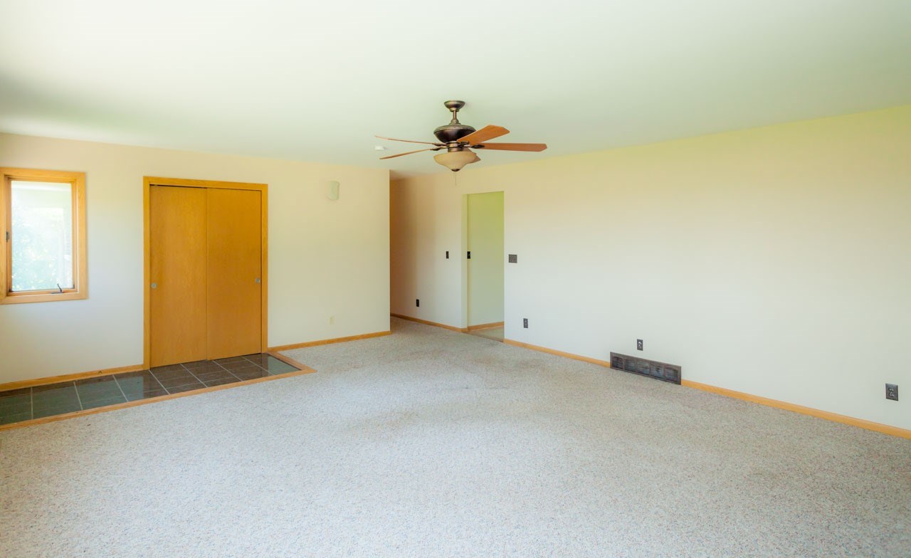 18660 Burr Oak Road Capron, IL 61012 - Photo 6 of 25 an empty room with a window and a ceiling fan