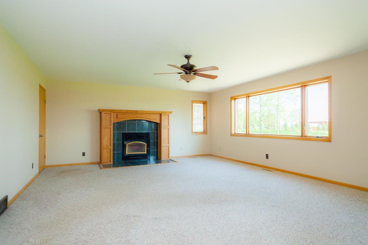 18660 Burr Oak Road Capron, IL 61012 - Photo 7 of 25 an empty room with windows and fireplace